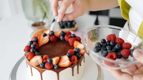 Fresh berries and chocolate used for a handcrafted celebration cake