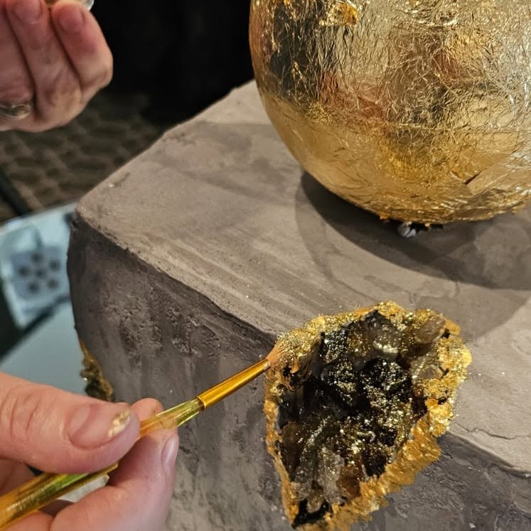 Hand-painted gold geode detail on a celebration cake